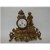 Image 1 : A CAST METAL MANTEL CLOCK, late 19th century, figure and scroll, 8cm enamel Roman dial, height 29...