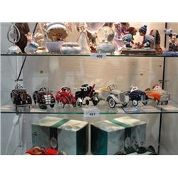 Shelf of 7 die cast pedal cars