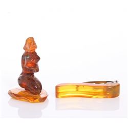 An amber figure carving and a Bakelite tie clip.  SIZE: