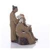 Image 2 : Early 20th Century mud men figurine of three men at a s