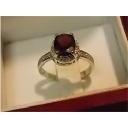 RING - OVAL FACETTED GARNET & DIAMOND SOLITARE RING IN STERLING SILVER SETTING WITH PLATINUM OVERLAY
