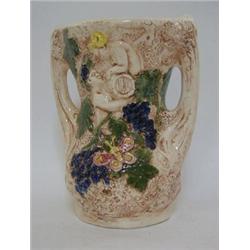 A CROWN DEVON TWIN HANDLED VASE, relief scene of cherubs collecting grapes, cream and coloured gl...