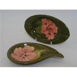 TWO MOORCROFT ASHTRAYS, tube-lined Fuscha design, both with paper labels, 'Potters to the late Qu...