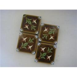 A SET OF FOUR MINTON HOLLINS ENCAUSTIC FLOOR TILES, late 19th Century, stylized botanical subject...