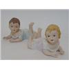 Image 1 : A PAIR OF TINTED BISQUE PIANO BABIES, 20th Century, length 15cm (2)  £80-100...