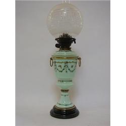 A PASTEL GREEN OPAQUE GLASS OIL LAMP, late 19th Century, over-enamelled foliage and insects, chim...