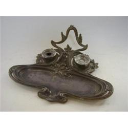 AN ART NOUVEAU METAL DESK STAND, of stylized naturalistic form, no ink wells, length 30cm  £30-40...