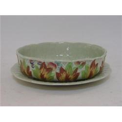 A CLARICE CLIFF SALAD DRAINER, AND STAND, moulded foliage, celadon ground, No.39a, diameter 20cm...