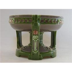 A FIN DE SIECLE ART POTTERY COMPORT, circular bowl on three stylized supports, olive and green gl...