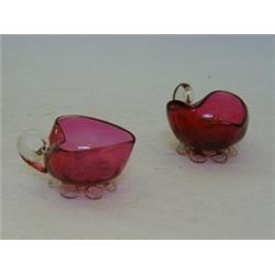 A PAIR OF RUBY GLASS CONSERVE DISHES, heart shape, clear loop handles and pincered bases, pontil...