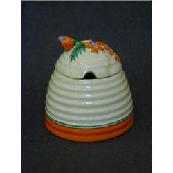 A CLARICE CLIFF HONEY POT, beehive shape, 'Marguerite' pattern, height 10cm, (hairline to cover)...