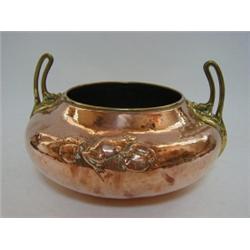 AN ARTS AND CRAFTS COPPER PLANTER, hammered finish with frogs and insects, stylized twin brass ha...