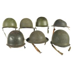 Seven American Military Helmets, Including Two Fixed Bale M1 Helmets