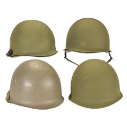 Four U.S. M1 Helmets, Including an Early Fixed Bale Model, with Extra Liners, Covers, and Related Ac