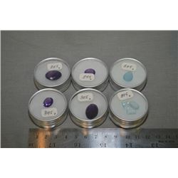 Selection of loose gemstones including four oval cut faceted amethyst gemstone and a selection of aq
