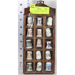 SET OF 15 CERAMIC THIMBLES IN WOODEN SHELF