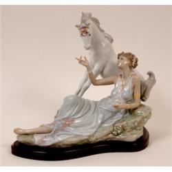 A Lladro Group, of a reclining young girl with a unicorn, impressed No 6007, on a shaped wooden p...