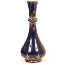 A Sevres Vase, decorated gilt arabesque scrolls on a blue ground, 23 cm  See illustration £30 - 4...