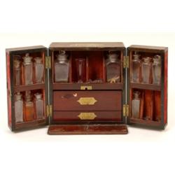 A 19th Century Mahogany Apothecary's Mahogany Cabinet, the fitted interior with glass bottles  Se...