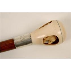 A Walking Stick, the ivory handle carved the three wise monkeys, the silver band initialled BAT...