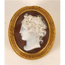 An Oval Gilt Metal Box, with cameo inset to the cover within a Greek key border, 5 cm  See illust...