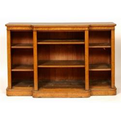 A Victorian Oak Break Front Open Bookcase, with six adjustable shelves standing on a plinth base,...