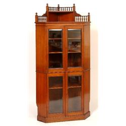 A Victorian Walnut Corner Cupboard, the shelved gallery top above two pairs of bevelled glass doo...