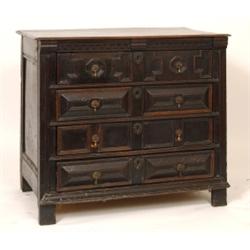 An Early 18th Century Oak Chest, the dentil moulded frieze above four graduated long drawers, on...