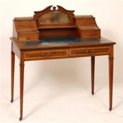 An Edwardian Inlaid Mahogany Writing Desk, the mirrored back with two concave stationery compartm...
