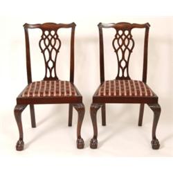 A Set of Six Mahogany Dining Chairs, with pierced splats, drop in seats, and on carved cabriole b...