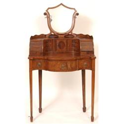 A Mahogany Dressing Table, the shield shaped mirror above a superstructure and three frieze drawe...