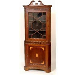 An Edwardian Inlaid Mahogany Corner Cupboard, the swan neck pediment above a dentil moulded corni...