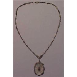 Silver filigree necklace has 1" oval pendant