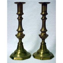 A pair of cast brass push-up candlesticks, ro