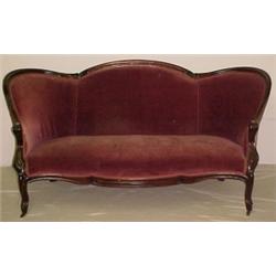 Walnut Victorian sofa, carved crest over upho