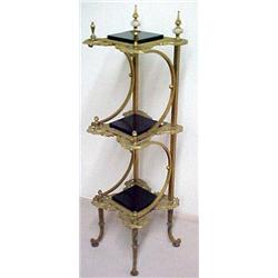 Brass three tiered stand, back finials with a