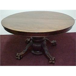 Round mahogany dining table with six leaves,