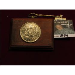 Walnut Plaque with 1922 U.S. Peace Silver Dollar attached. Toned Uncirculated.