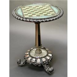 UNUSUAL VICTORIAN CIRCULAR EBONISED TRIPOD GAMES TABLE, the top with glazed surface over a green...