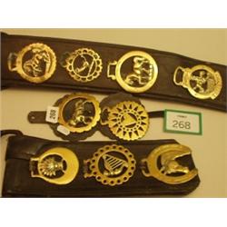 Nine old horse brasses on leather straps…