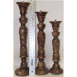 SET OF THREE HAND CARVED WOOD CANDLE STANDS