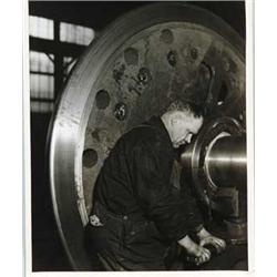 PHOTOGRAPHIC PRINT OF A WORKER AT AN AMERICAN LOCOMOTIVE FACTORY BY LEWIS W. HINE