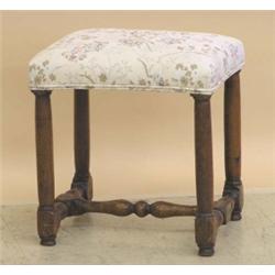 WILLIAM AND MARY OAK STOOL, English. Circa 1690. The rectangular padded top above turned legs j...