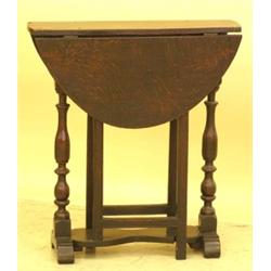 JACOBEAN OAK GATELEG TABLE, English. Late 17th Century. The narrow rectangular top hinged with...