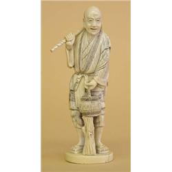 CARVED IVORY FIGURE OF A FARMER, Japanese. Signed in a cinnabar seal. Carrying a hoe and a stra...