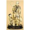 Image 1 : CARVED IVORY GROUP, Japanese. Depicting an entertainer with his child assistant and a monkey. M...