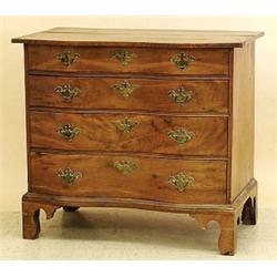 CHIPPENDALE WALNUT REVERSE SERPENTINE CHEST OF DRAWERS, American. 18th Century. The oblong top...