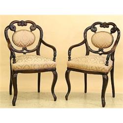 SET OF TWELVE GEORGIAN CARVED FRUITWOOD DINING ARMCHAIRS, English. 19th Century. Each backrest...