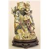 Image 1 : CARVED, STAINED AND POLYCHROMED IVORY GROUP, Chinese. Depicting a seated immortal surrounded by...