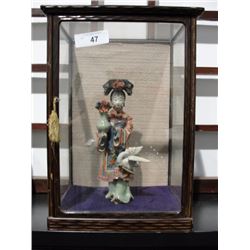 Geisha girl in glass case